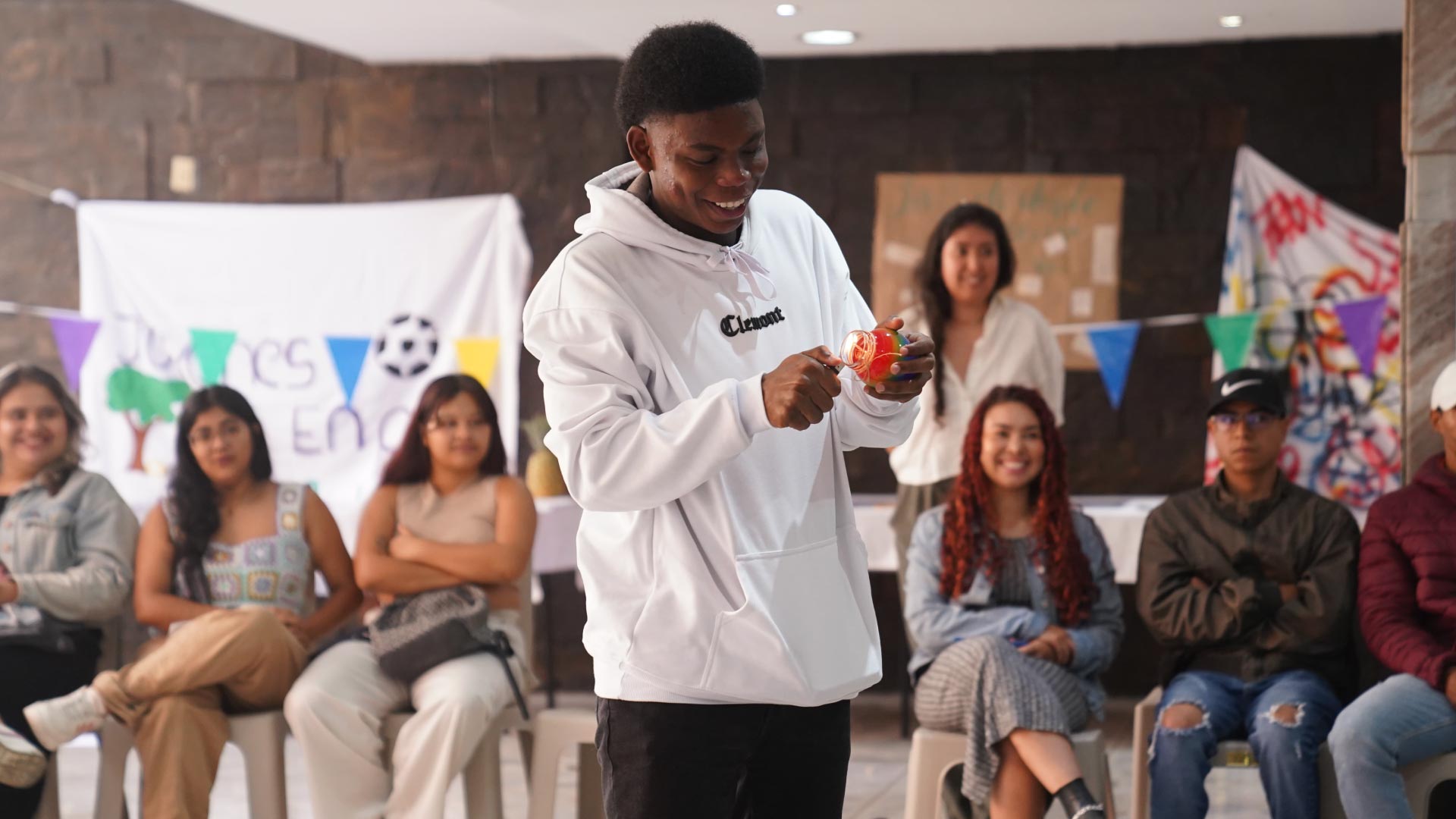 joven encendiendo una vela en la mitad de un grupo de jovenes