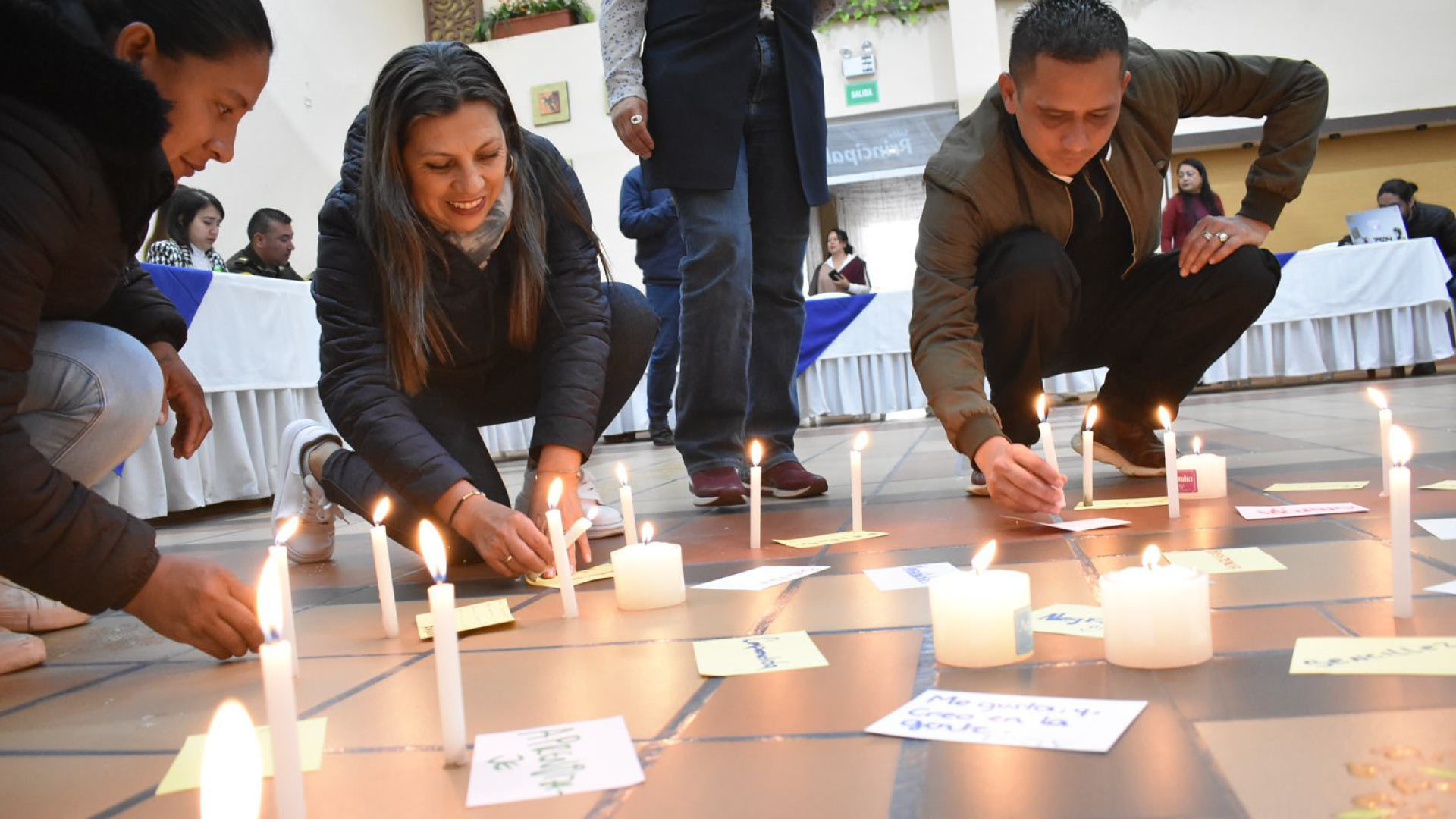 personas prendiendo velas en el suelo